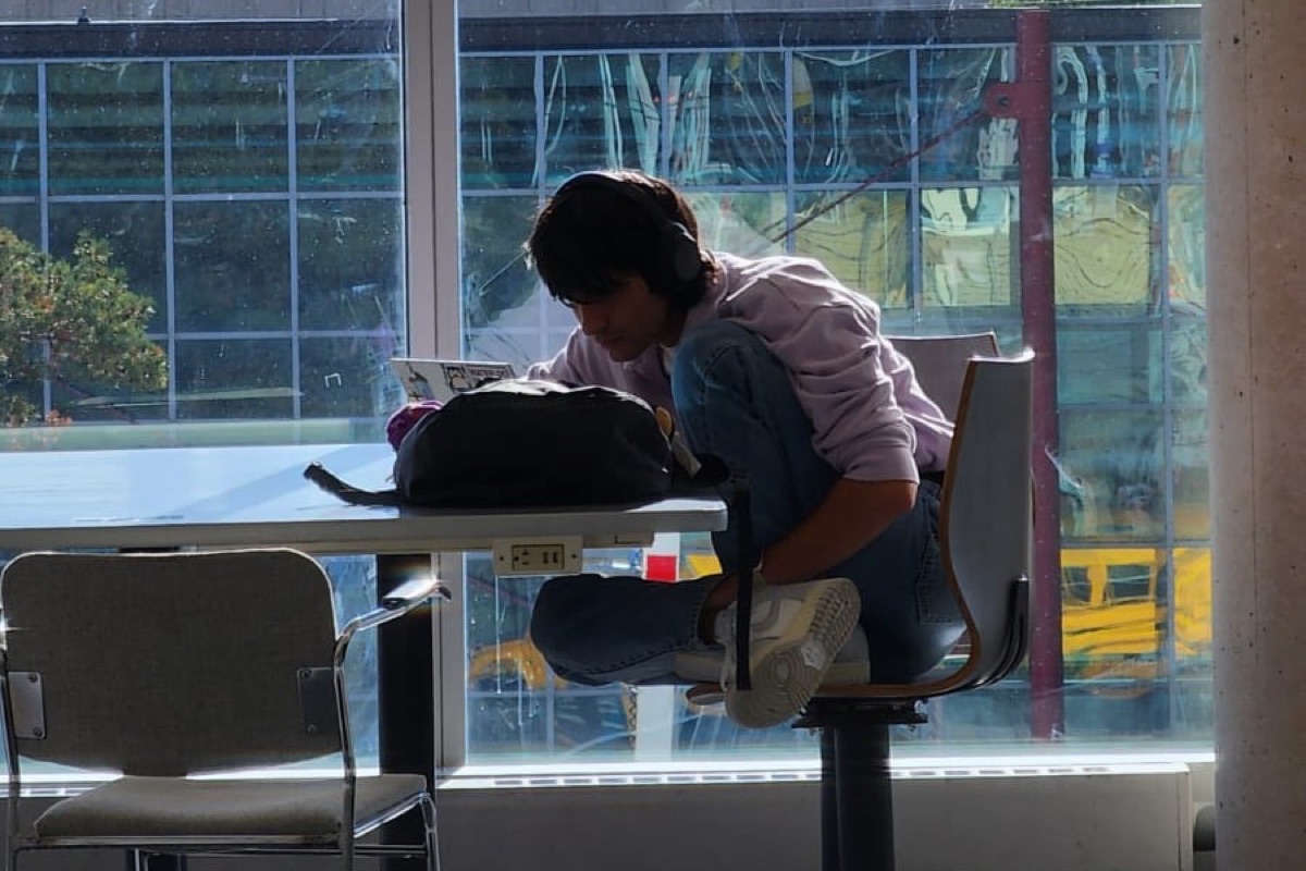 Zain working by a sunny window